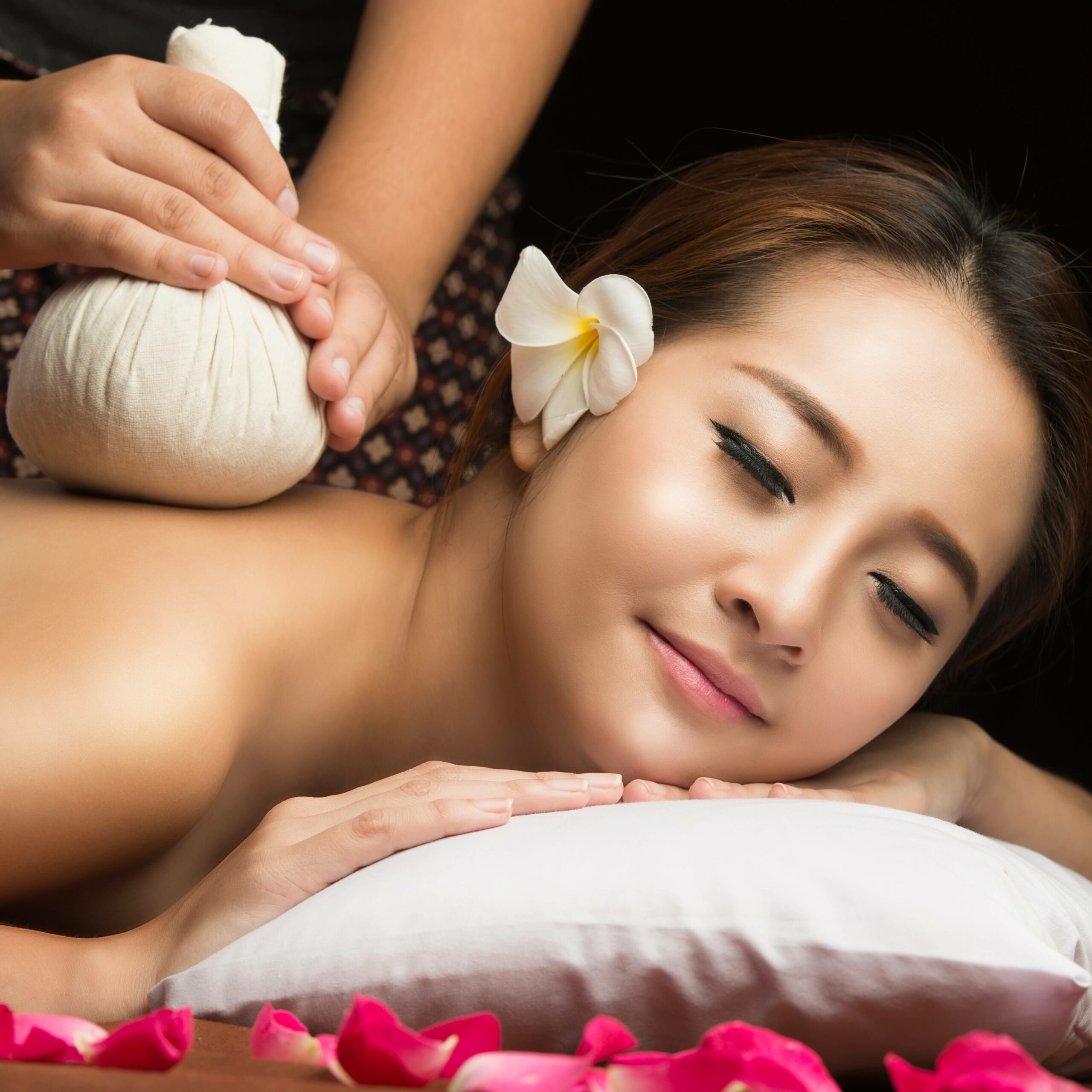 asian-woman-getting-thai-herbal-compress-massage-spa-square